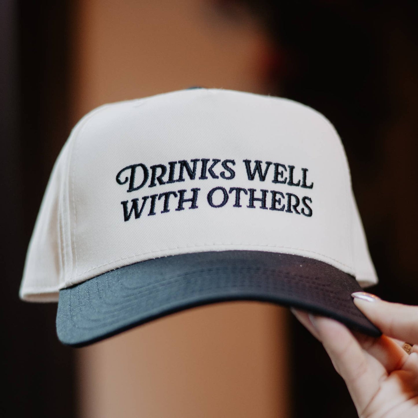 DRINKS WELL WITH OTHERS TRUCKER HAT