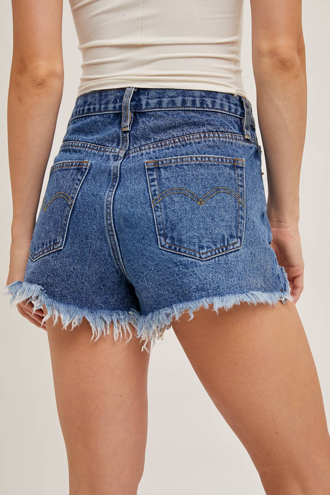 DISTRESSED MID-RISE DENIM SHORTS